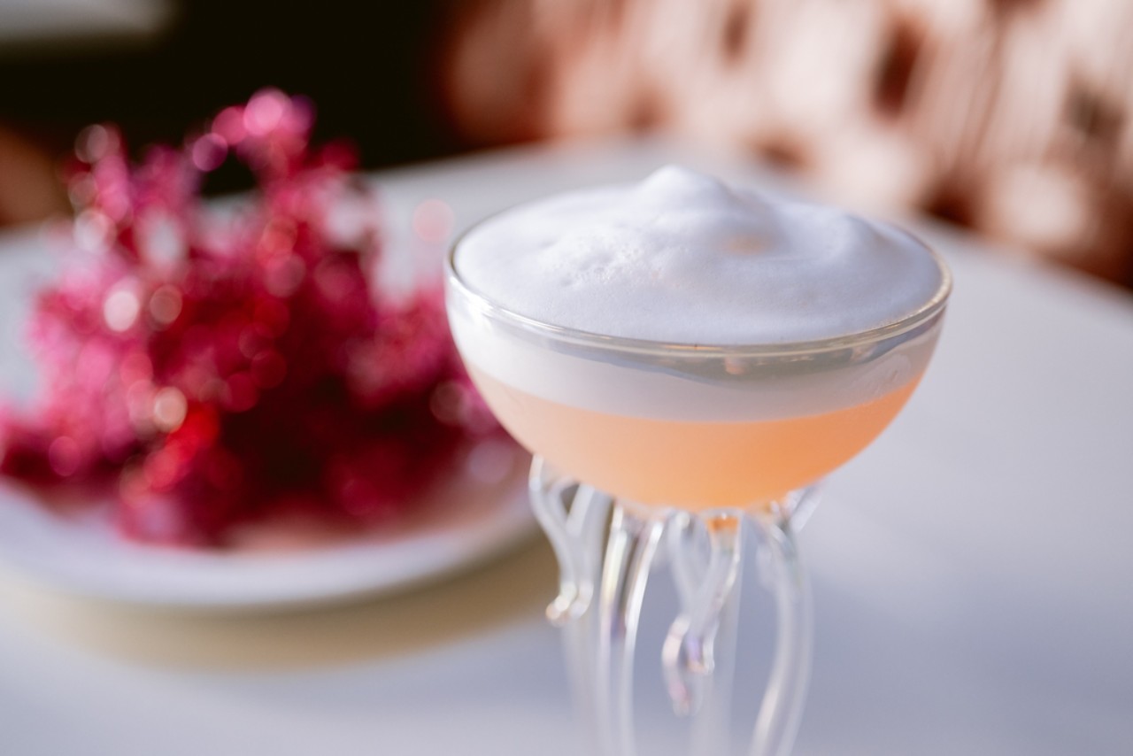 a glass with a drink on it