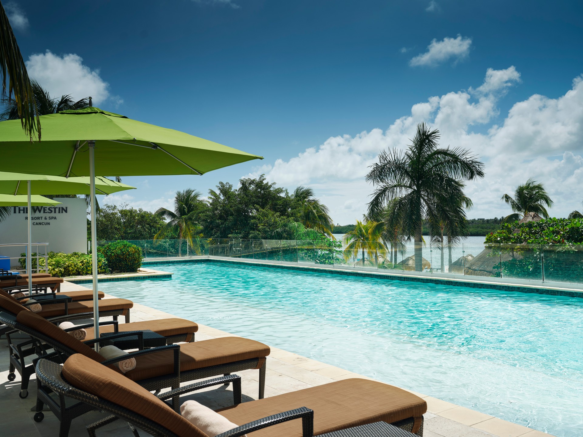 a pool with chairs and umbrellas
