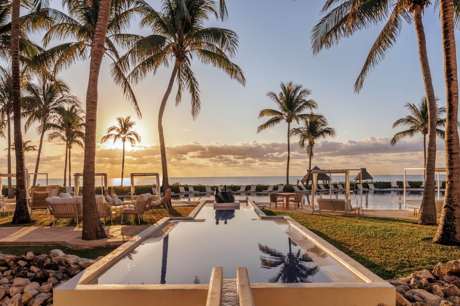 a pool with palm trees and a pool in the background