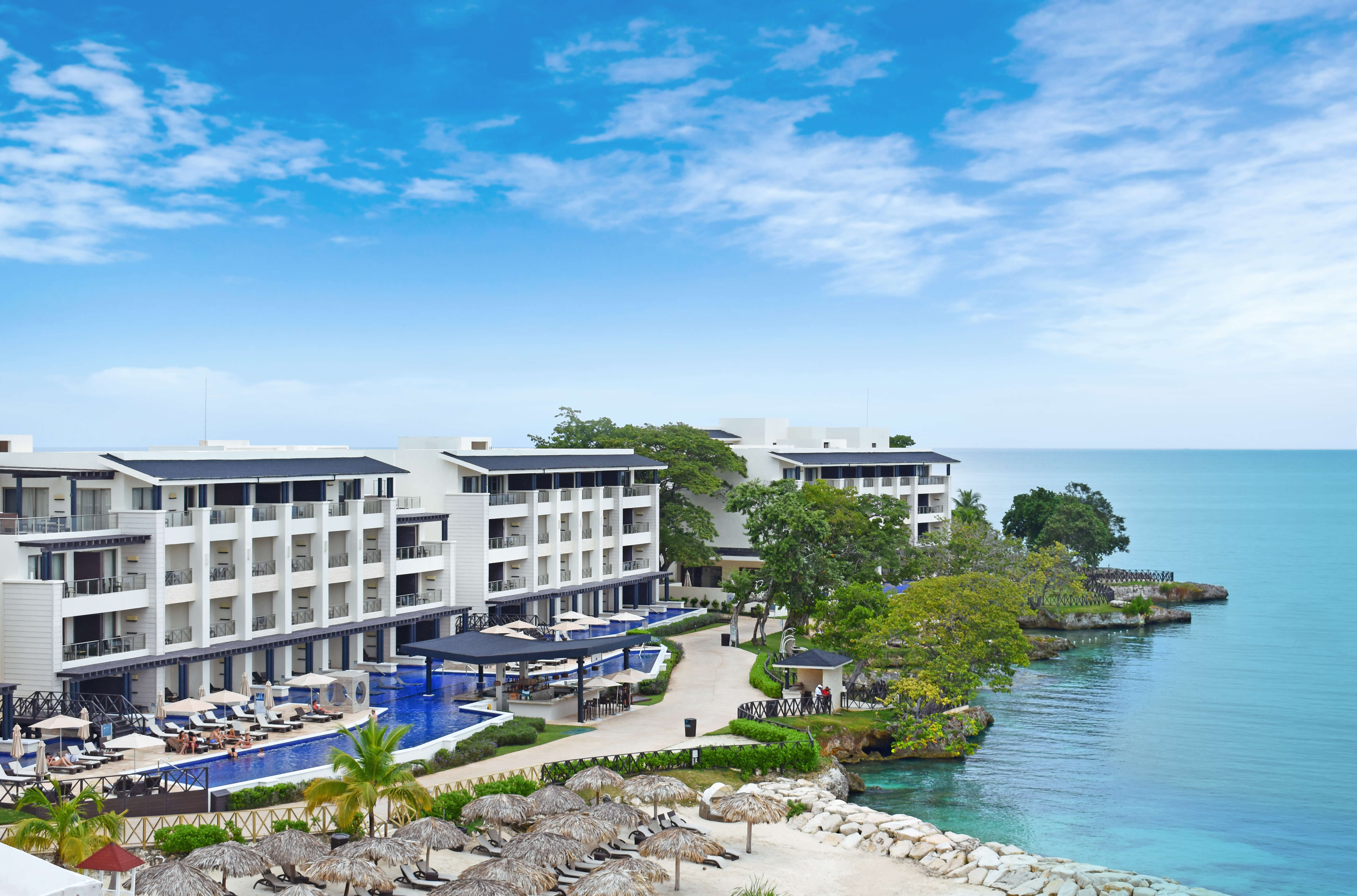 a hotel with a pool and a beach