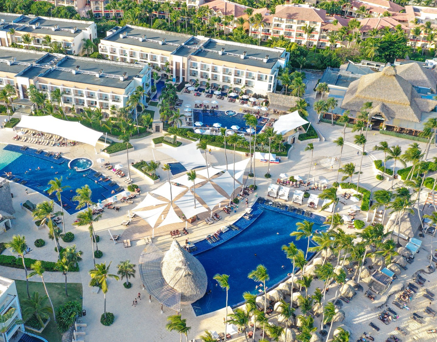 a resort with a pool and palm trees