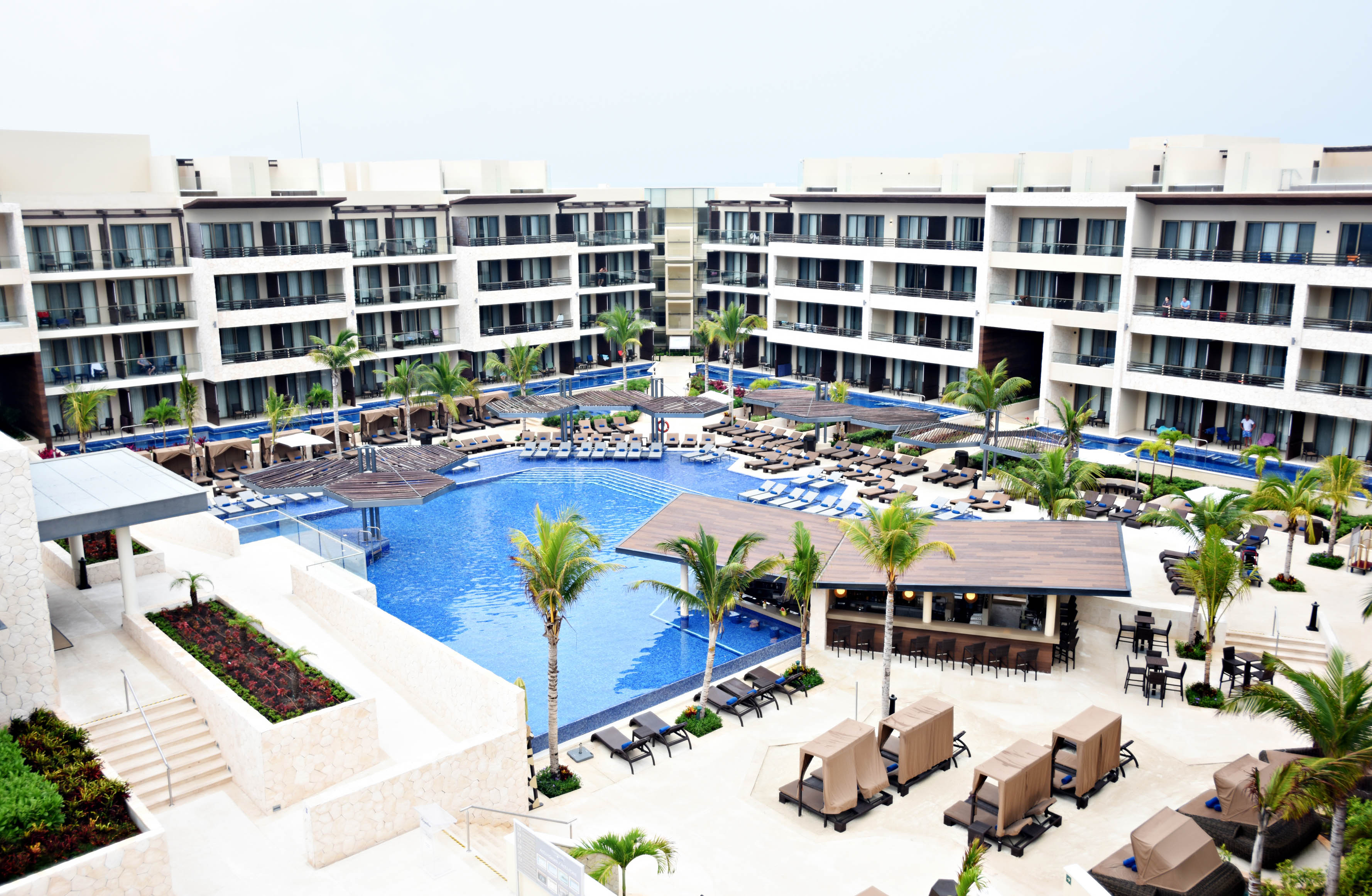a pool and a building with palm trees