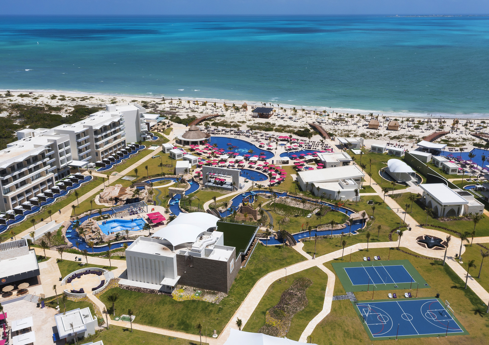 a beach with buildings and a swimming pool