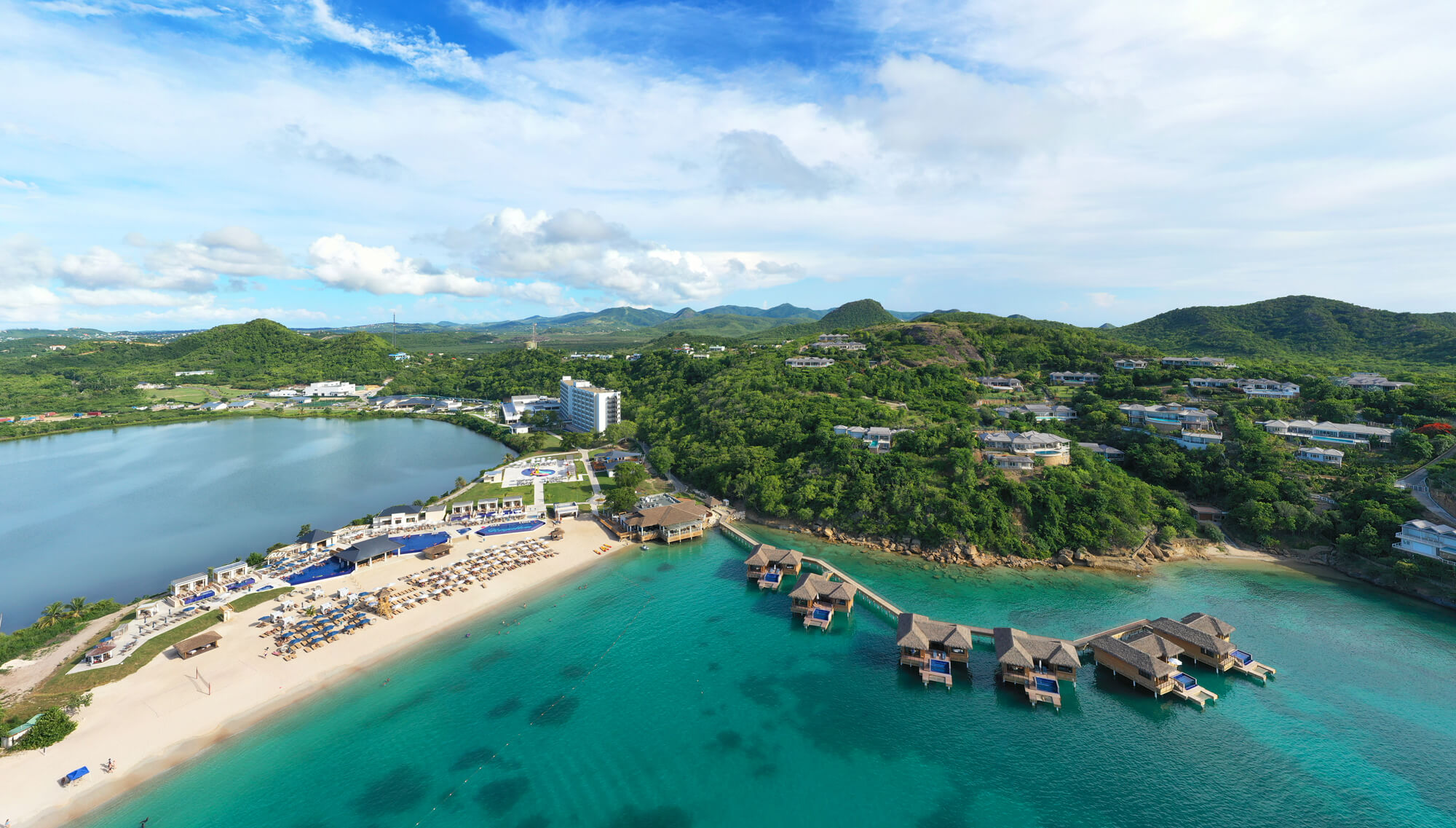 a beach with houses and a body of water