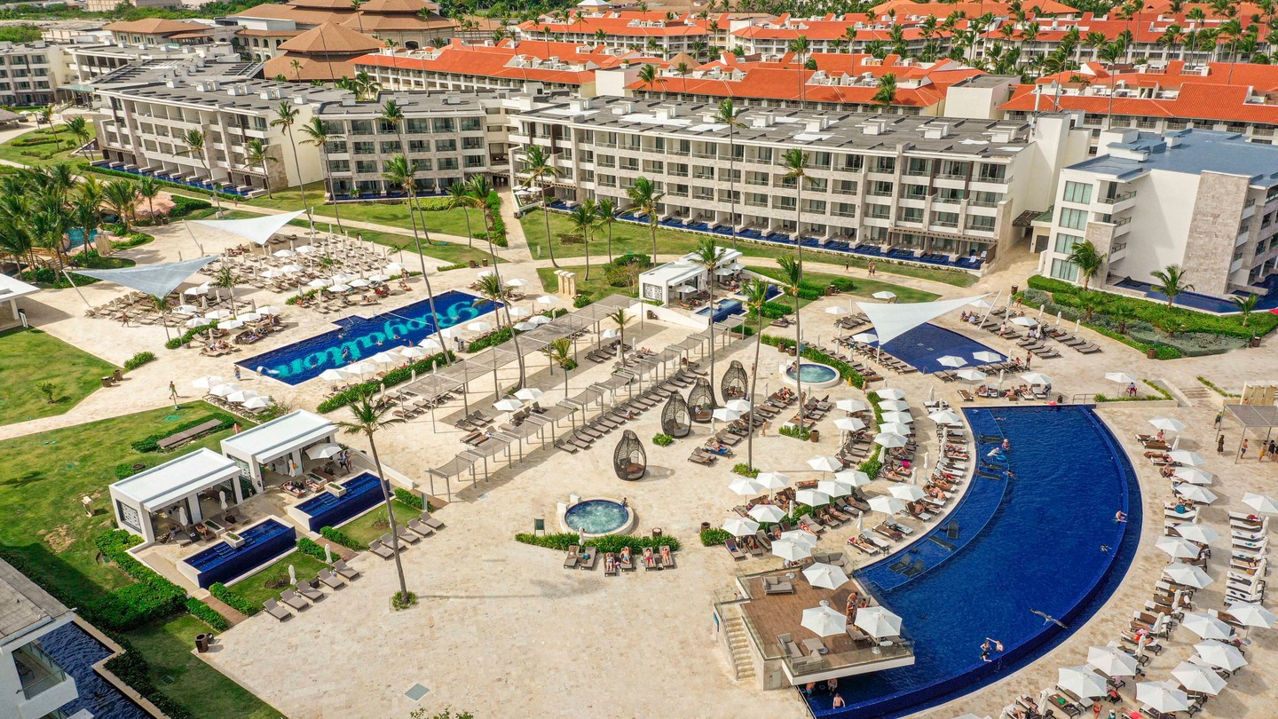 a resort with a pool and palm trees