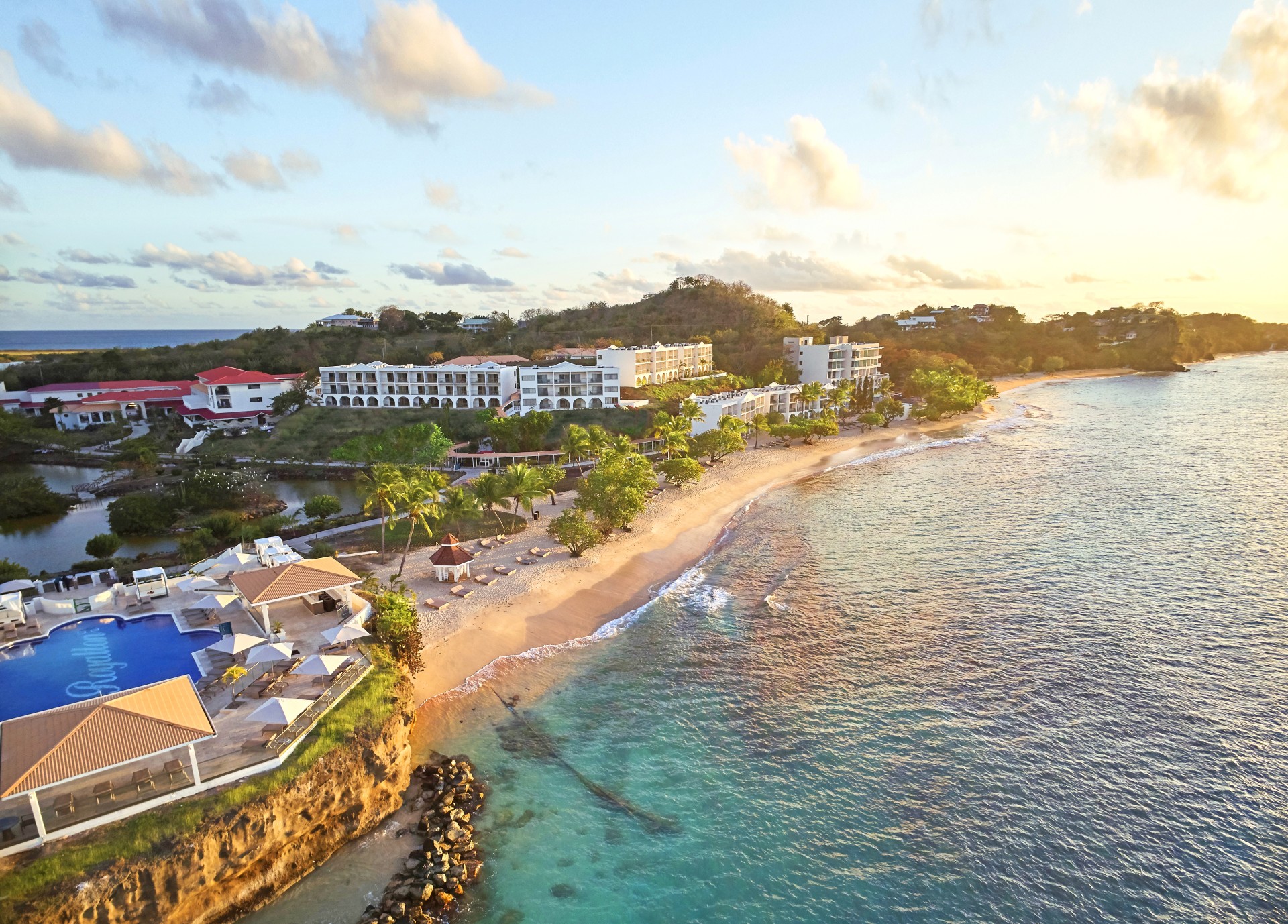 a beach with buildings and a body of water