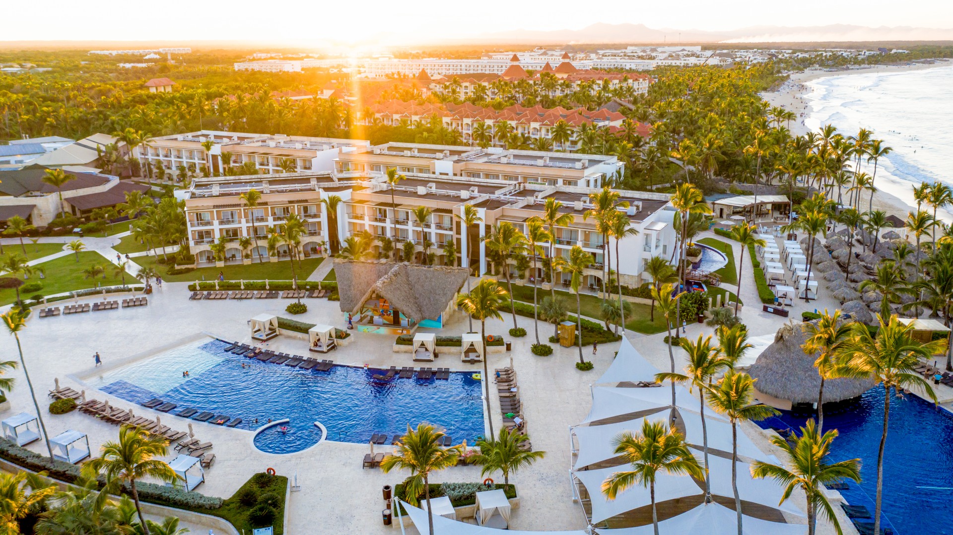 a pool and palm trees in a resort