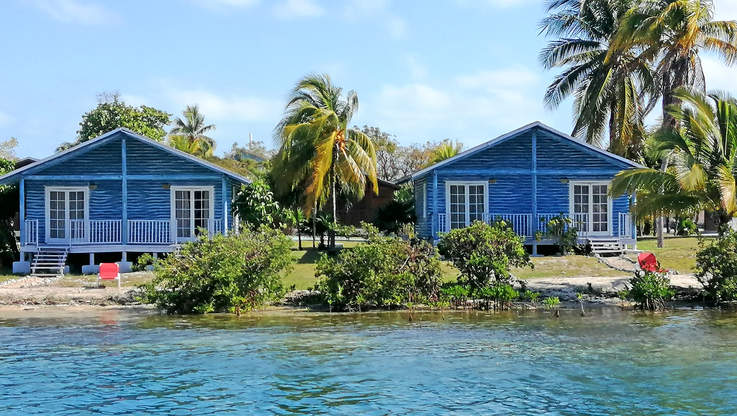 a couple of blue houses by the water