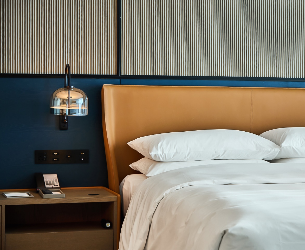 a bed with a lamp and a table