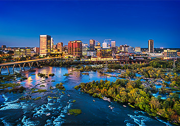 a cityscape with trees and a bridge over water