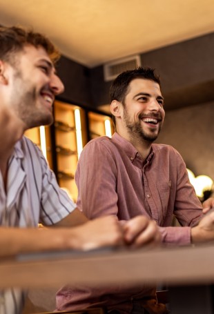 a group of people laughing at a table