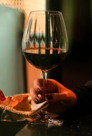 a hand holding a glass of wine