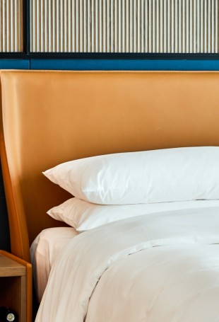 a bed with a lamp and a table