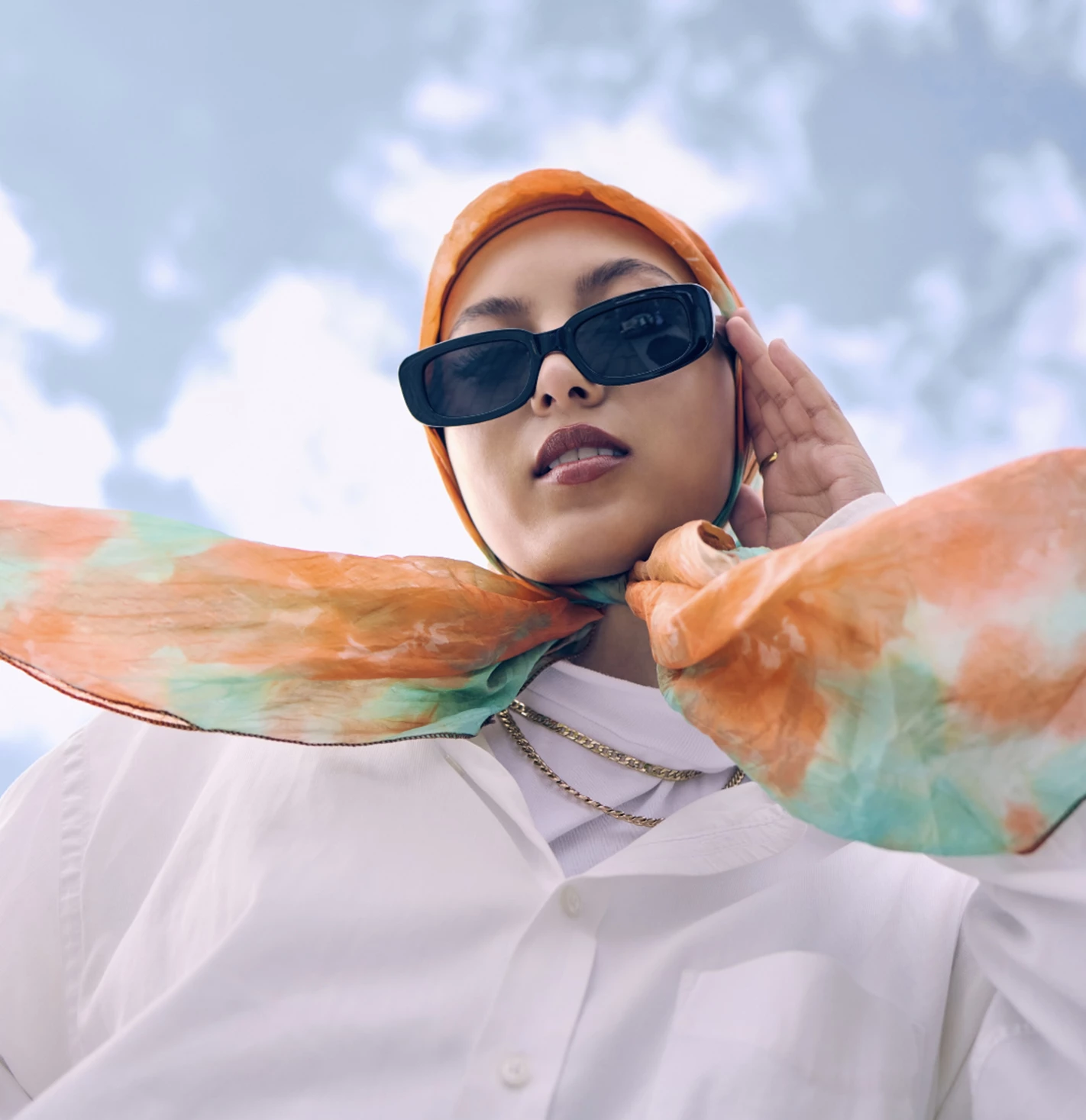 a woman wearing sunglasses and a scarf