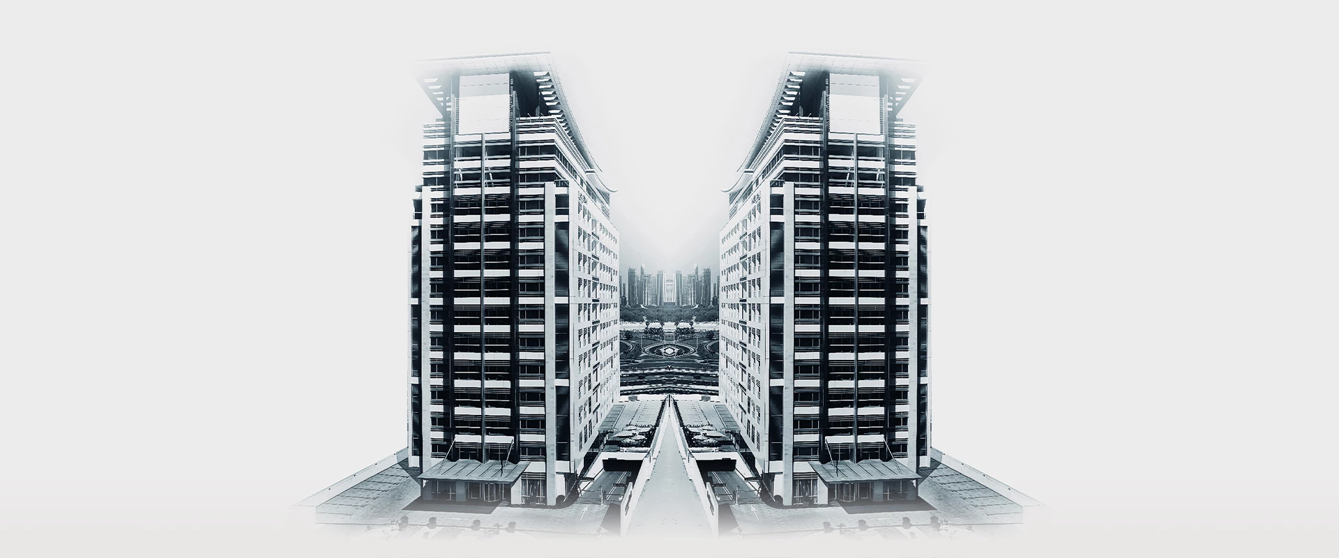 a two tall buildings with a city in the background