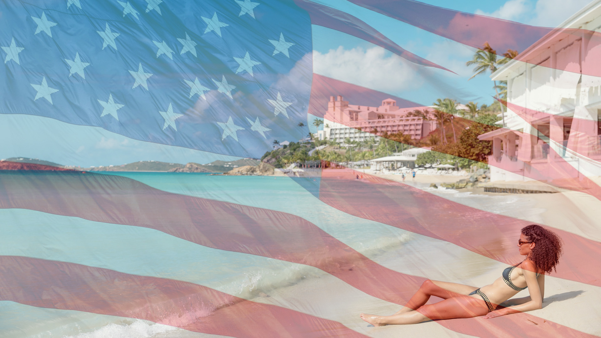 a woman lying on a beach with a flag