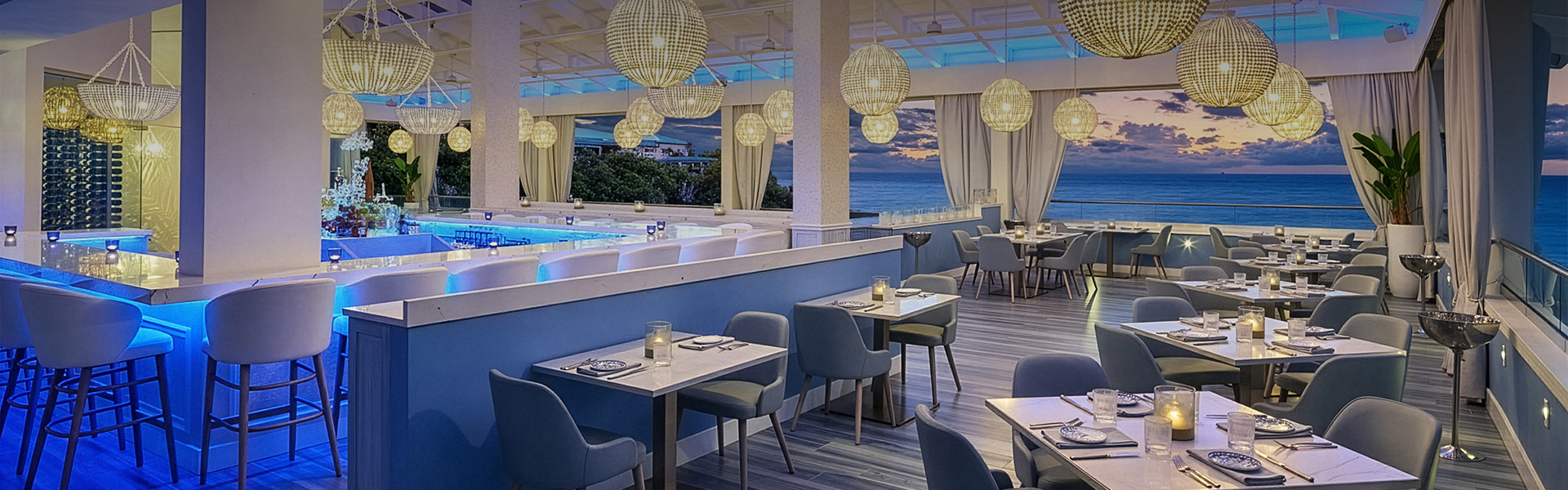 a restaurant with tables and chairs and a pool