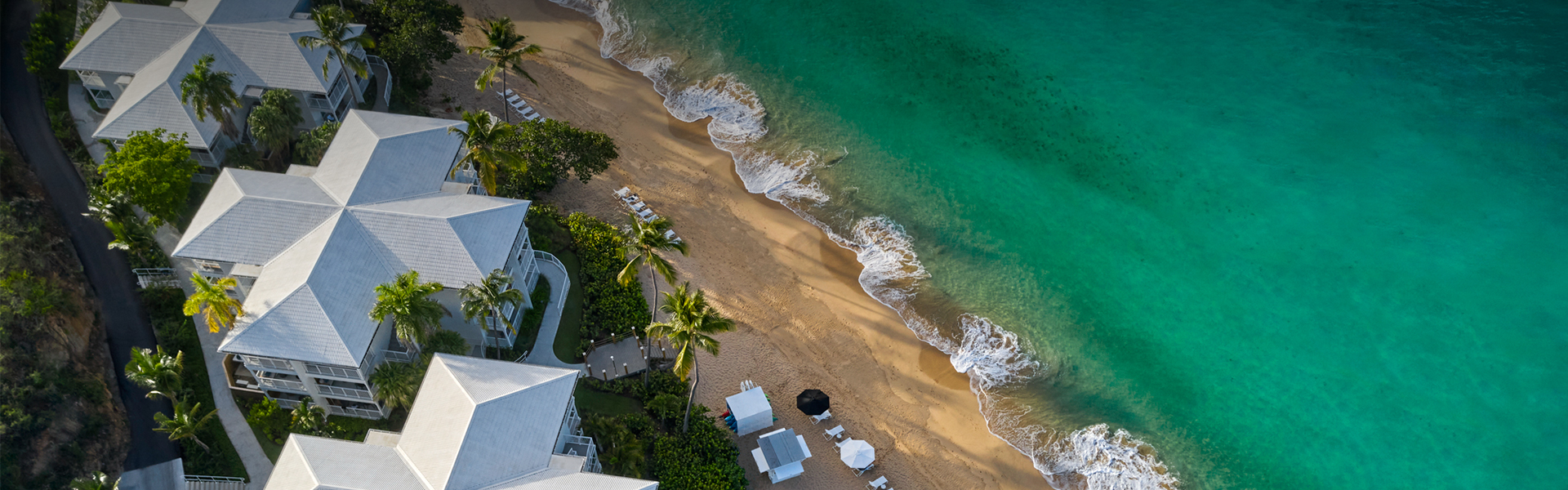 a beach with chairs and umbrellas