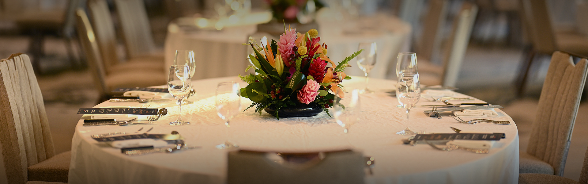 a table with flowers and glasses