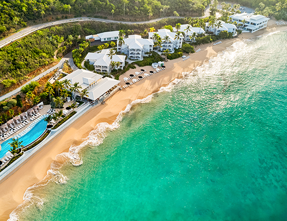 a beach with white buildings and a pool