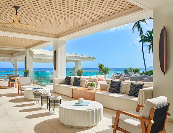 a large outdoor patio with white furniture and a table