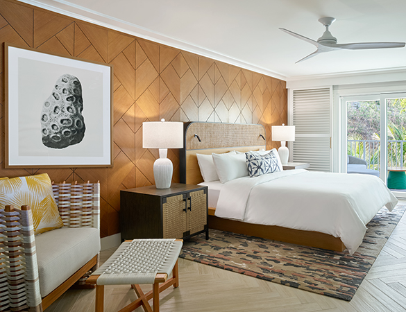 a room with a bed and chairs