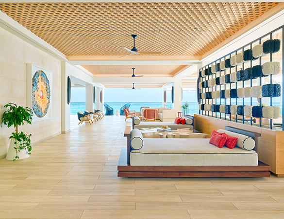 a room with a large couch and chairs