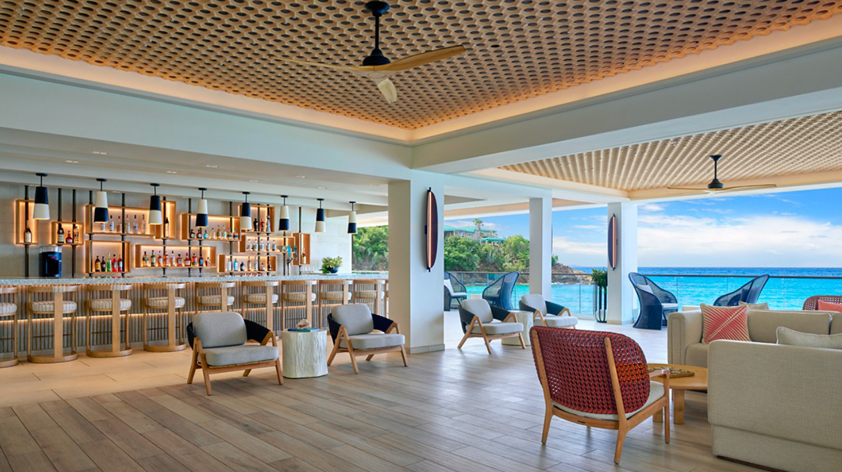 a room with a bar and chairs