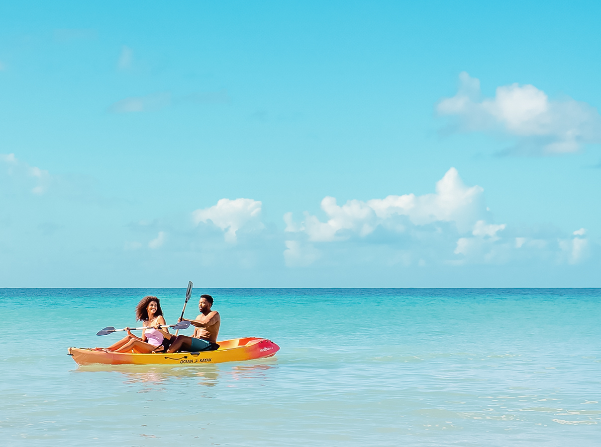 a man and woman in a kayak on the water