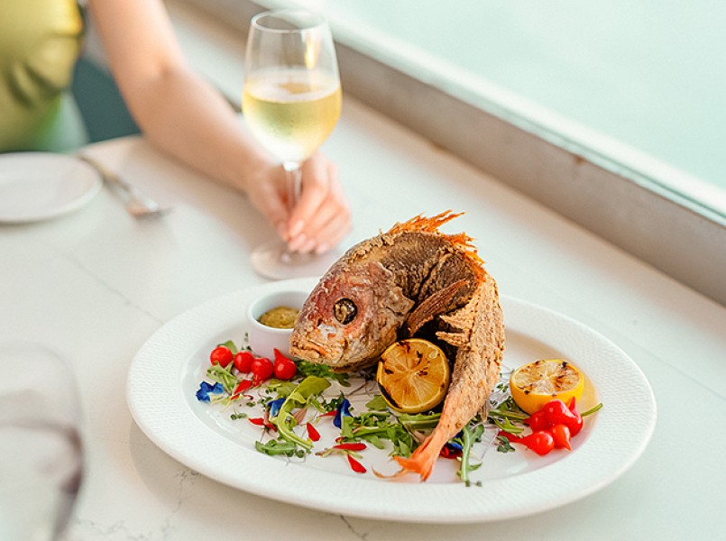 a plate of fish and lemons on a table