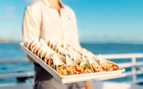 a person holding a tray of food