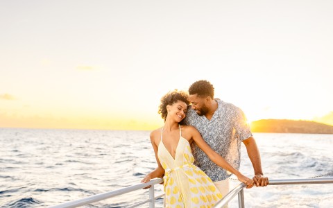 a man and woman standing on a boat