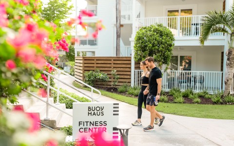 a man and woman walking outside of a building