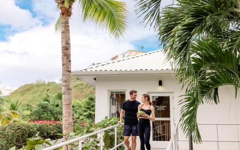 a man and woman walking down a walkway