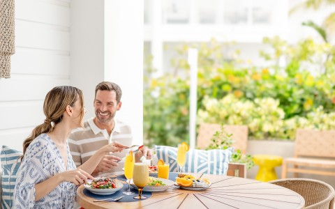 a man and woman eating at a table