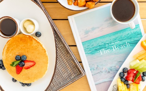 a plate of pancakes and fruit on a table