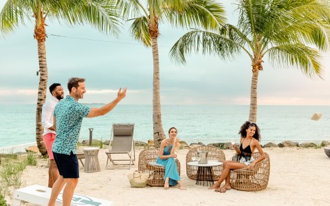a group of people sitting on chairs on a beach
