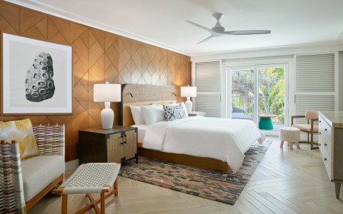 a bedroom with a bed and a chair