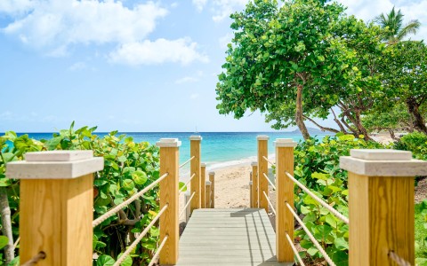 a wooden walkway leading to a beach