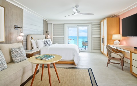 a room with a bed and a table and chairs