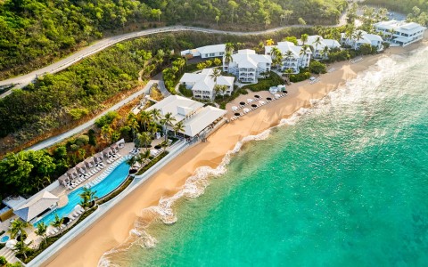a beach with a body of water and buildings