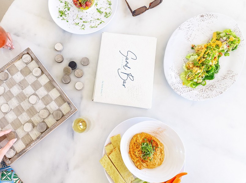 a table with plates of food and a book