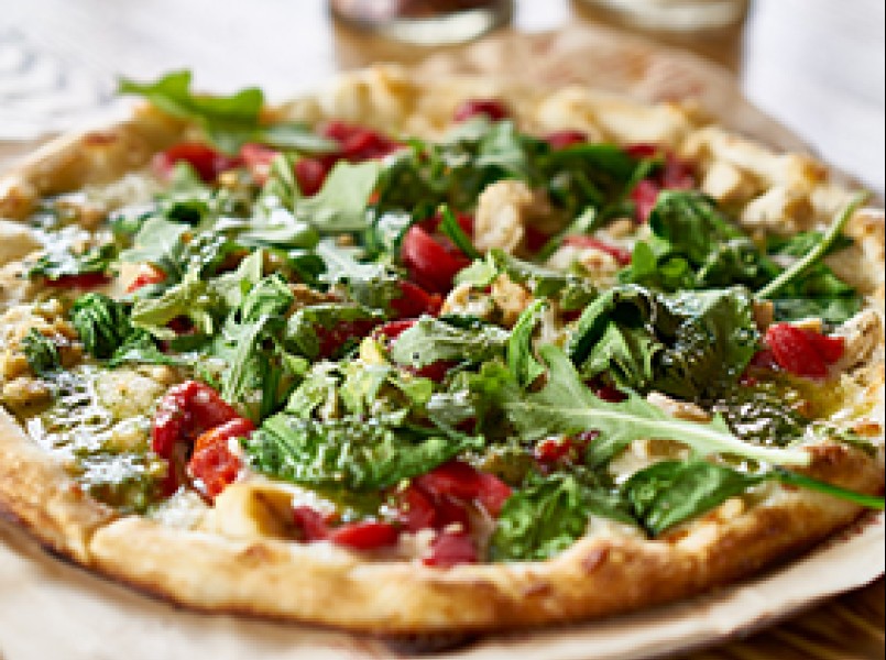 a pizza with vegetables on a plate