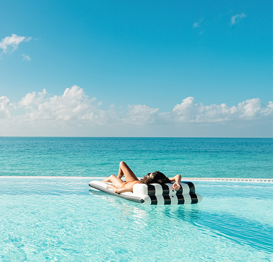 a woman lying on a mattress in a pool