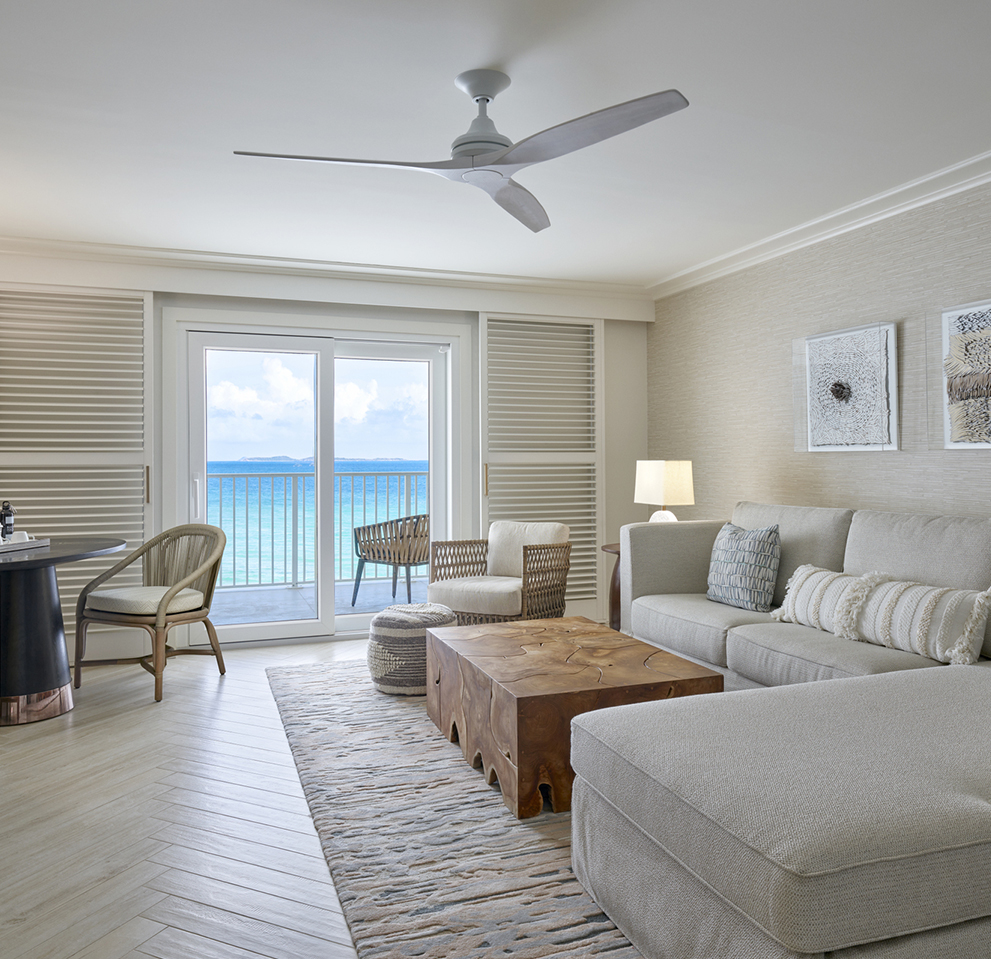 a living room with a large couch and a table and chairs