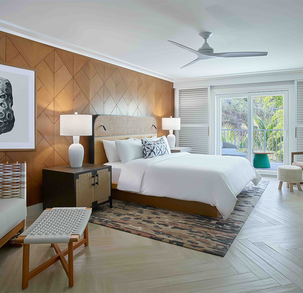 a bedroom with a bed and chairs