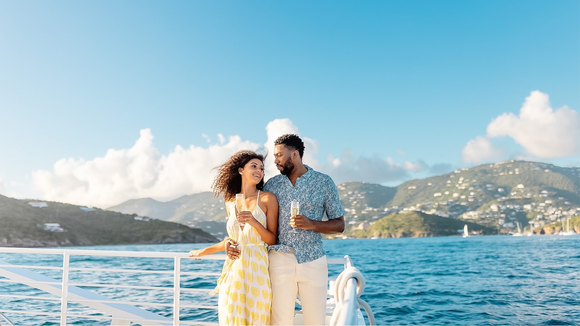 a man and woman standing on a boat