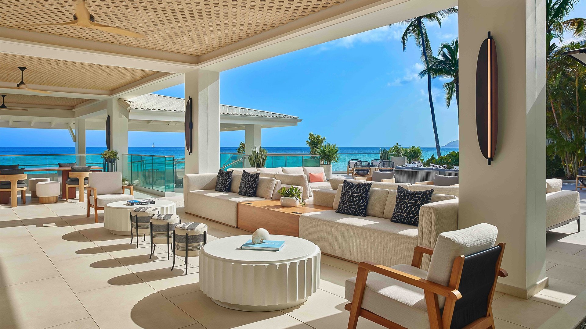 a patio with a large couch and chairs