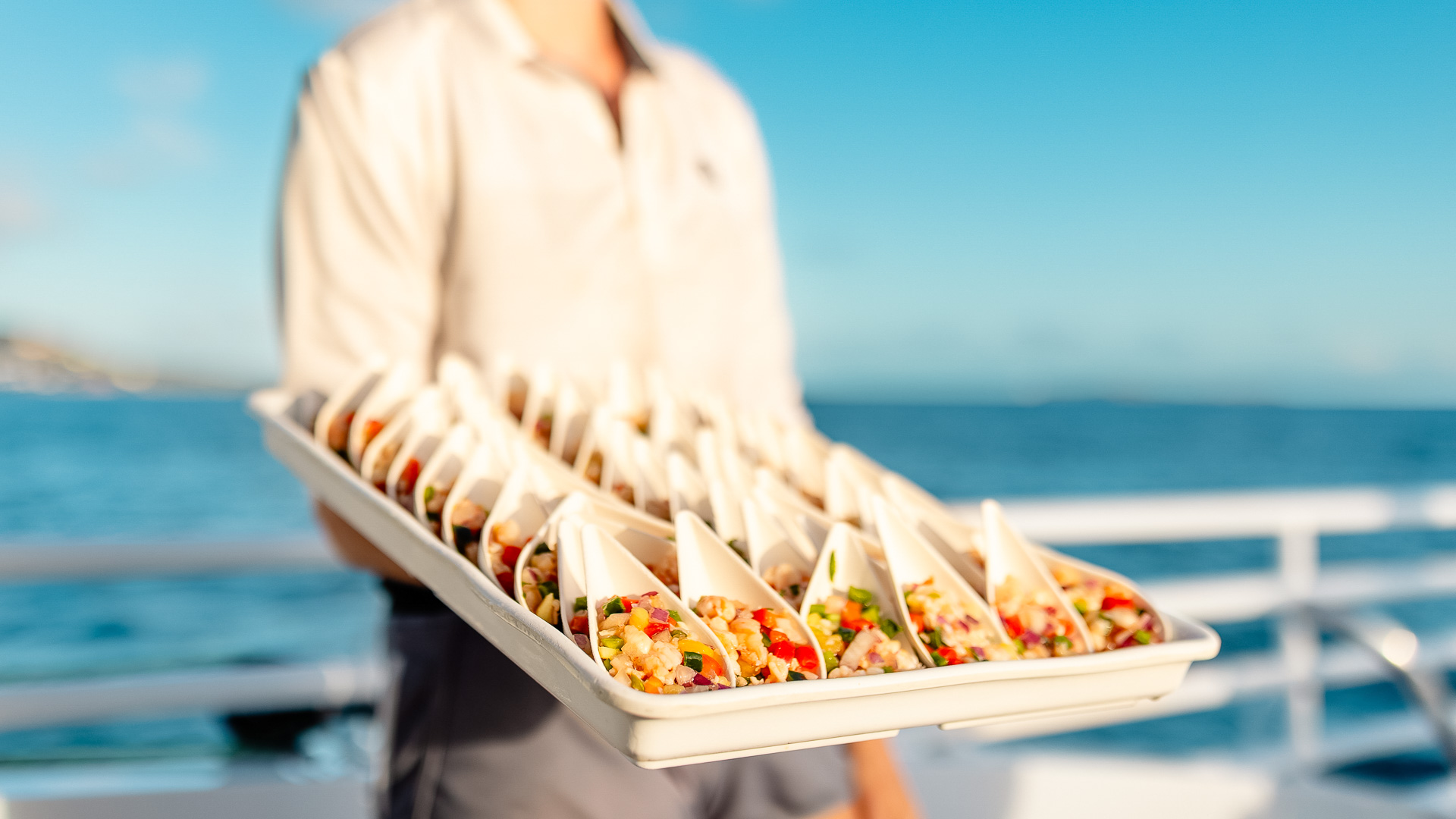 a person holding a tray of food