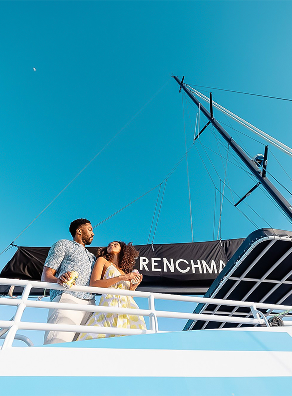 a man and woman standing on a boat